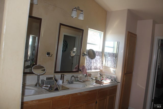 full bathroom featuring double vanity and a sink