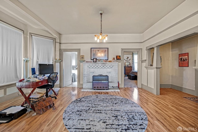 living room featuring a notable chandelier and light hardwood / wood-style floors