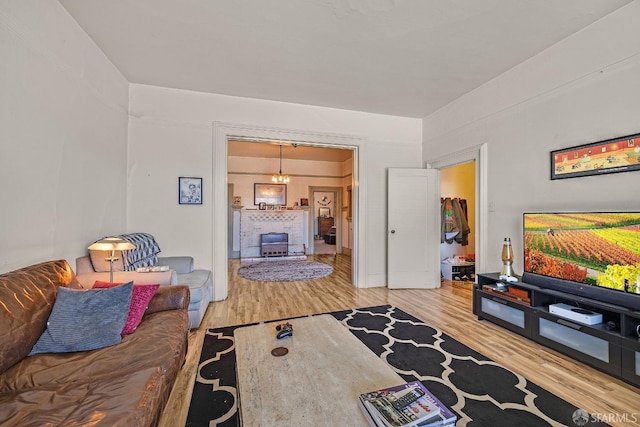 living room with hardwood / wood-style flooring and an inviting chandelier