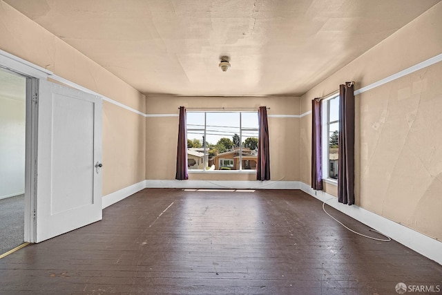 spare room featuring dark hardwood / wood-style flooring