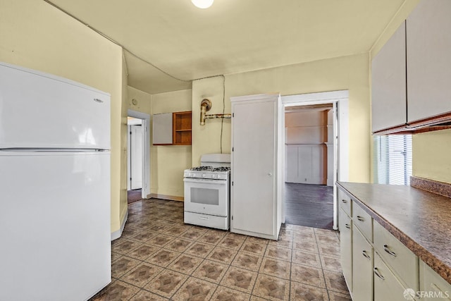 kitchen with white cabinetry and white appliances