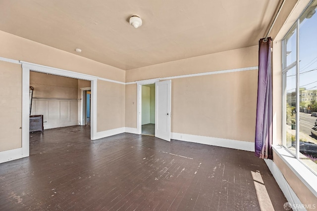 spare room featuring dark wood-type flooring