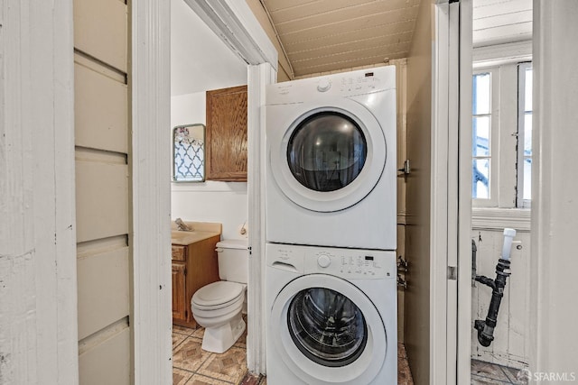 washroom featuring stacked washer and dryer