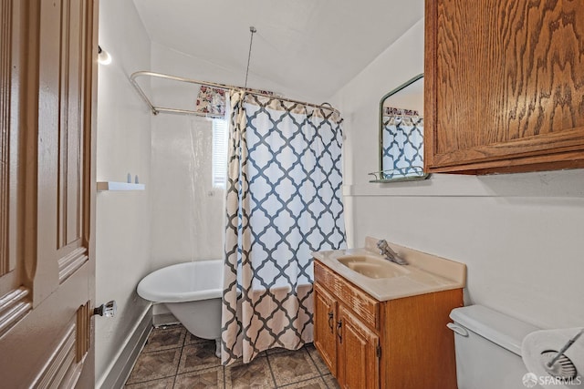 bathroom with vanity, vaulted ceiling, and toilet