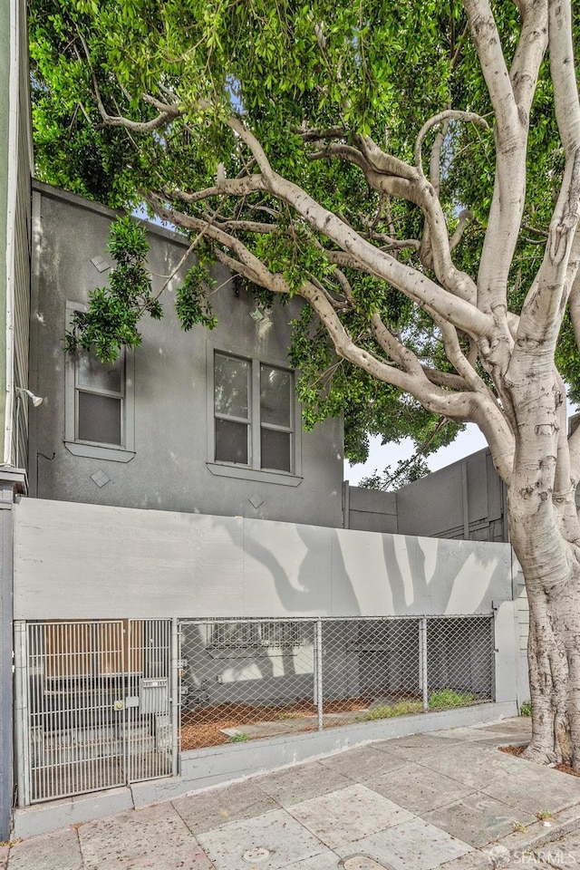 333-335 Potrero Ave, San Francisco, CA 94103 - view of property exterior with stucco siding and fence private yard