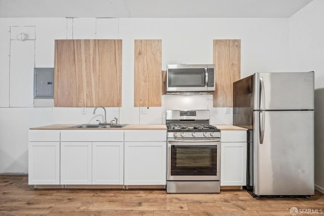 kitchen with white cabinetry, electric panel, stainless steel appliances, light wood-type flooring, and sink