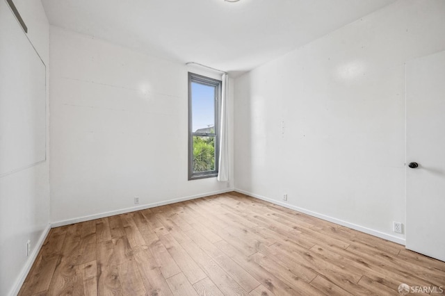 spare room with light hardwood / wood-style floors