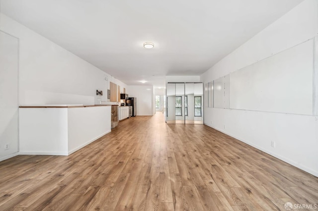 unfurnished living room featuring light wood-type flooring