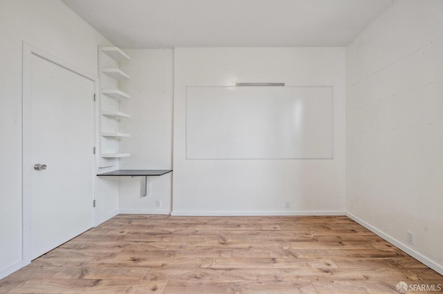 unfurnished room with light wood-type flooring