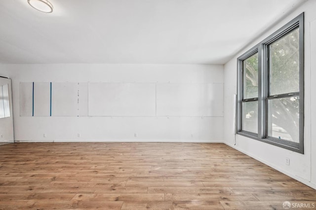 unfurnished room with light hardwood / wood-style flooring