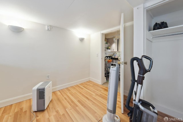 exercise room with hardwood / wood-style floors