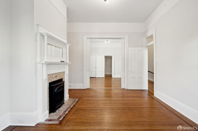 unfurnished living room with wood-type flooring