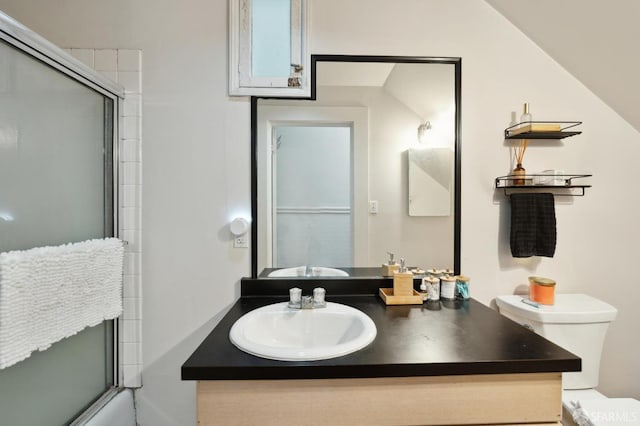 bathroom featuring walk in shower, vanity, and toilet