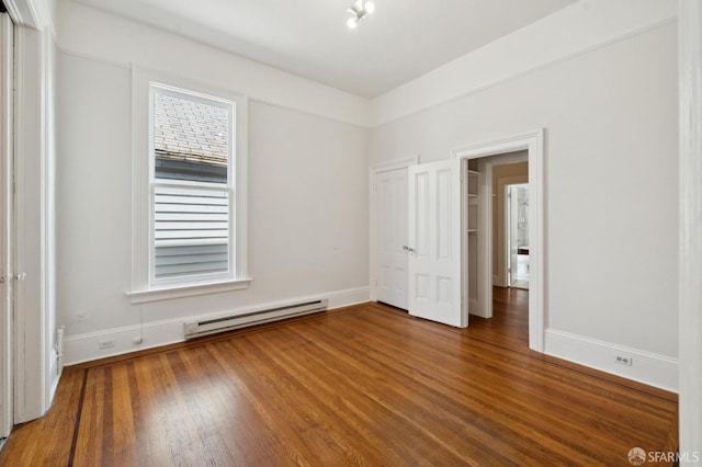 unfurnished bedroom with a baseboard radiator and hardwood / wood-style floors