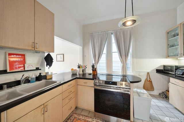 kitchen with light brown cabinetry, decorative light fixtures, appliances with stainless steel finishes, and kitchen peninsula