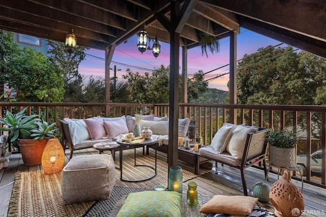 deck at dusk with an outdoor hangout area