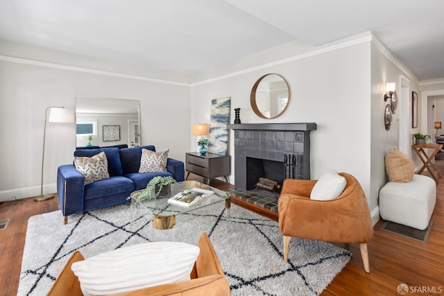 287 Staples Ave, San Francisco, CA 94112 - living area with wood finished floors, a tile fireplace, crown molding, and baseboards