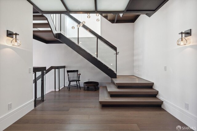 stairway with hardwood / wood-style floors