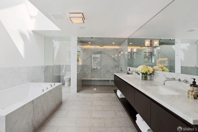 full bathroom featuring tile walls, vanity, independent shower and bath, toilet, and tile patterned floors