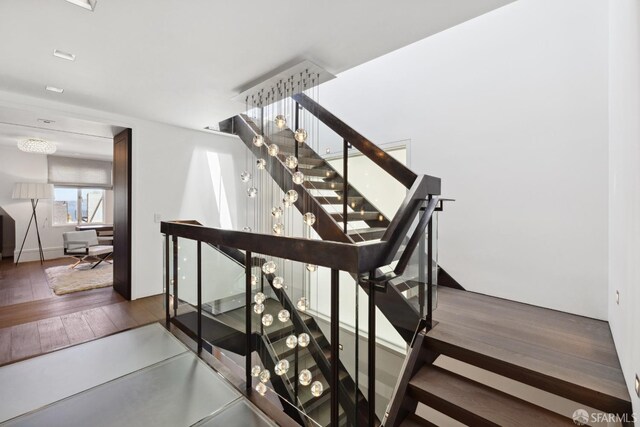 stairs featuring hardwood / wood-style flooring