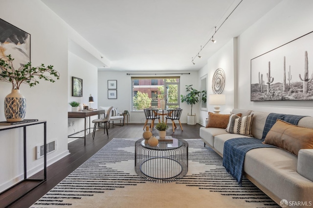 living room featuring track lighting and dark hardwood / wood-style flooring