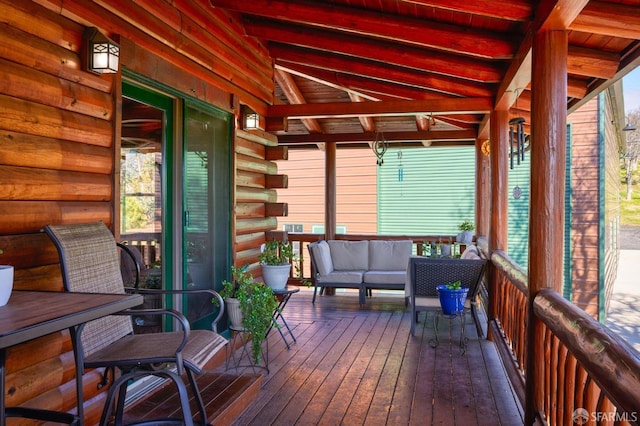 sunroom / solarium with vaulted ceiling with beams