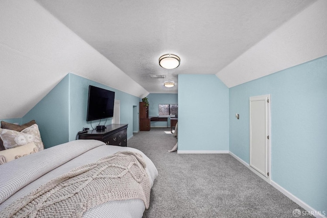 carpeted bedroom with lofted ceiling and a textured ceiling