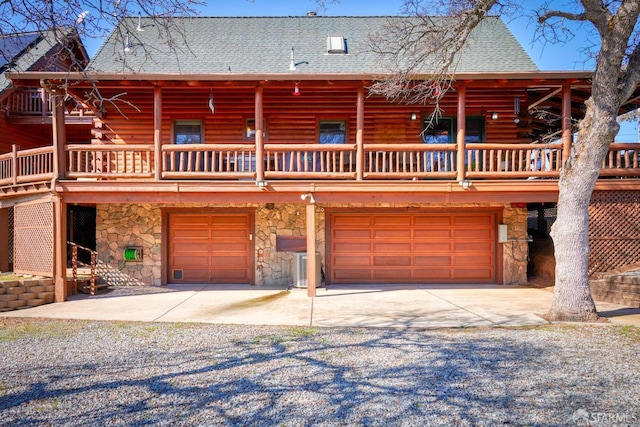 log cabin featuring a garage and a deck