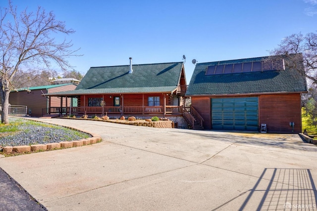 view of front of property featuring a porch and a garage