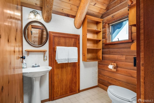 bathroom featuring beamed ceiling, toilet, sink, and wooden ceiling