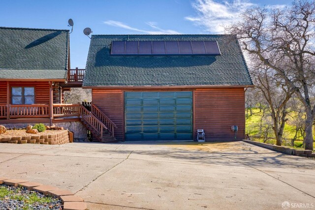 exterior space with a garage and a deck