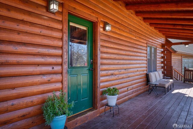 view of exterior entry with a porch