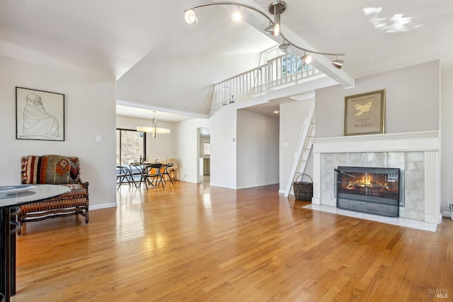 3062 Soda Canyon Rd, Napa, CA 94558 - living area featuring wood finished floors, a chandelier, a tile fireplace, and high vaulted ceiling