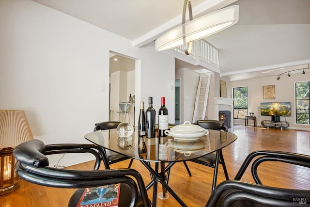 3062 Soda Canyon Rd, Napa, CA 94558 - dining room featuring wood finished floors, a lit fireplace, and beam ceiling