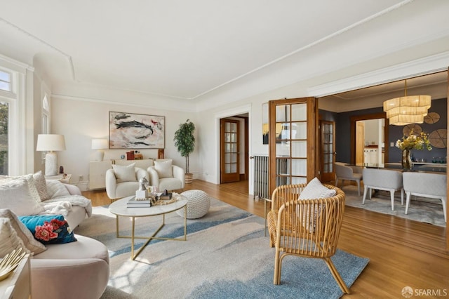 living room featuring an inviting chandelier and wood finished floors