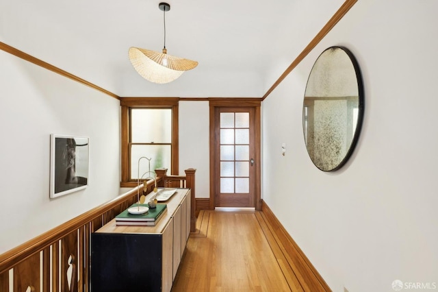 hall with a wainscoted wall and light wood-style flooring