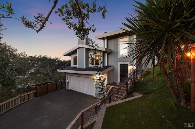 view of front of house with a garage and a yard