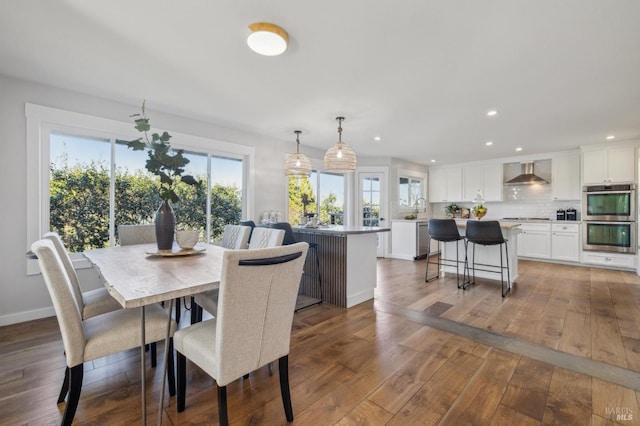 dining room with dark hardwood / wood-style flooring and sink