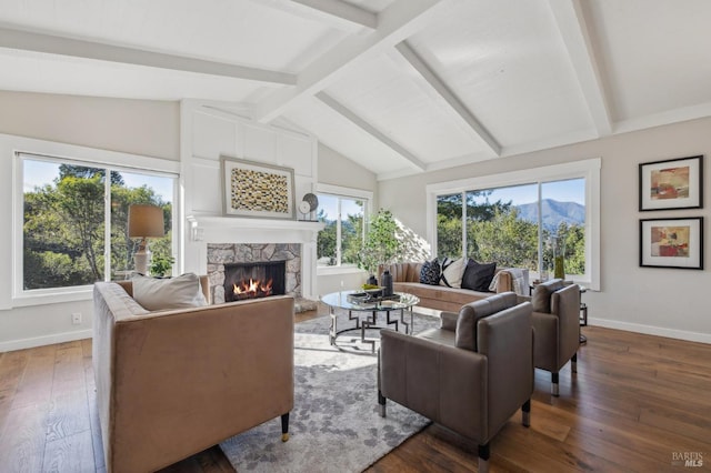 living room featuring dark hardwood / wood-style flooring, a wealth of natural light, and lofted ceiling with beams