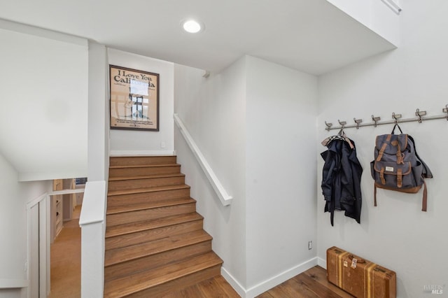 staircase featuring wood-type flooring