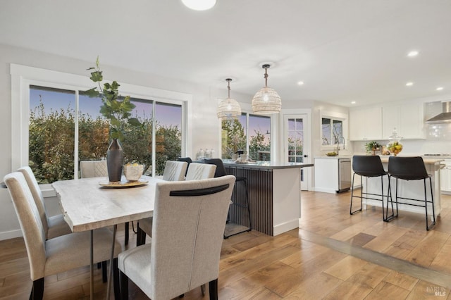 dining area with light hardwood / wood-style floors