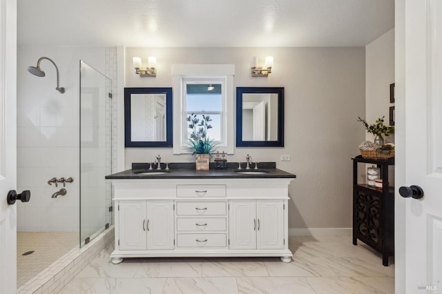 bathroom with vanity and a tile shower