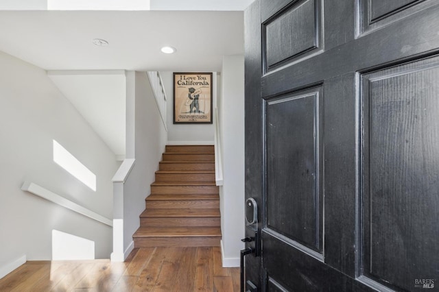 stairs with hardwood / wood-style flooring