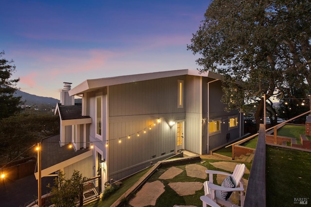 exterior space featuring a balcony, a yard, and a mountain view