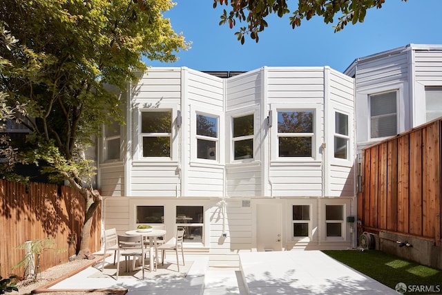 back of house featuring a patio and a fenced backyard