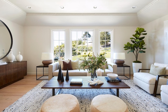 living room featuring baseboards, light wood finished floors, ornamental molding, and recessed lighting