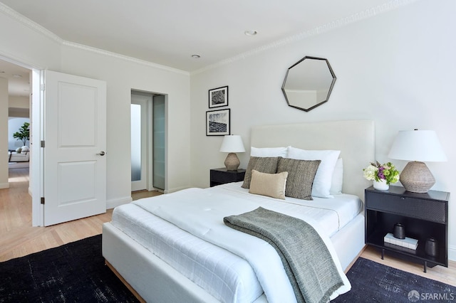 bedroom with wood finished floors and ornamental molding