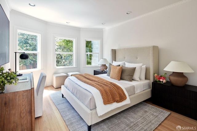 bedroom with light wood-style flooring, crown molding, and recessed lighting