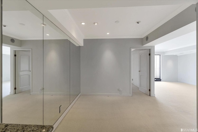 empty room with crown molding, recessed lighting, light colored carpet, and baseboards