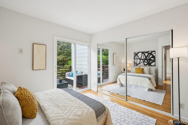 bedroom with wood finished floors and access to exterior